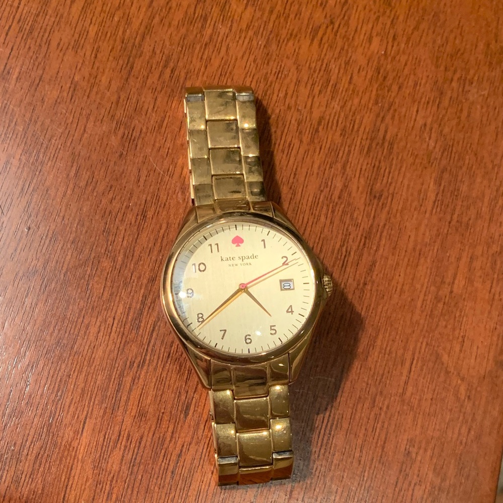 Kate Spade gold watch with pink accents.